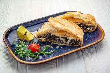 Homemade puff pastry pie with spinach and cheese.