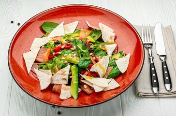 Salmon salad with spinach, vegetables and pine nuts.