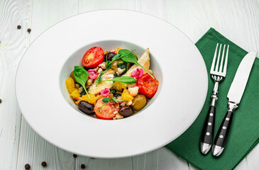 Salad with fish fillet, orange, olives, spinach and shrimps