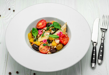 Salad with fish fillet, orange, olives, spinach and shrimps