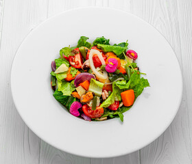 Salad with seafood and fresh vegetables. Healthy salad plate.