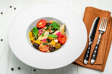 Salad with fish fillet, orange, olives, spinach and shrimps