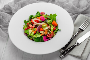 Salad with seafood and fresh vegetables. Healthy salad plate.