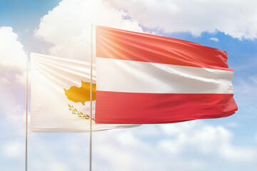 Sunny blue sky and flags of austria and cyprus