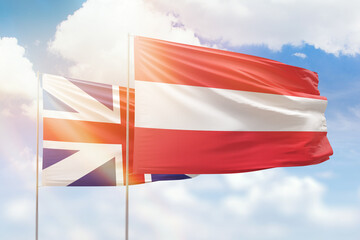 Sunny blue sky and flags of austria and great britain