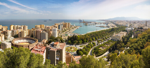 Panorama cityscape aerial view of Malaga, Spain. Cityhall and Plaza de Toros de Ronda bullring in...