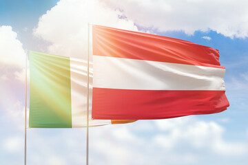 Sunny blue sky and flags of austria and ireland