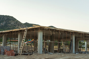 construction site of a house in turkey against the backdrop of mountains. erection of a reinforced...