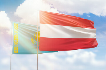 Sunny blue sky and flags of austria and kazakhstan