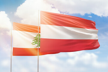 Sunny blue sky and flags of austria and lebanon
