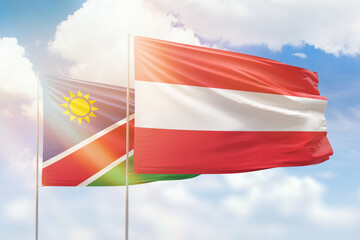 Sunny blue sky and flags of austria and namibia