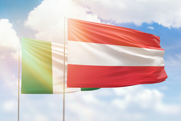 Sunny blue sky and flags of austria and nigeria
