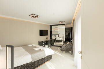 Interior of a luxury double bed hotel bedroom with black and white furniture