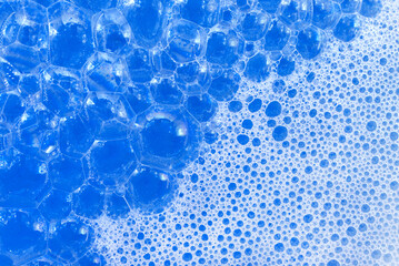 Soap foam. Background of dusty foam with bubbles of blue color for an inscription. Soap sud with copy-space