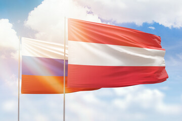 Sunny blue sky and flags of austria and russia