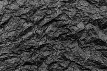 Texture of crumpled black paper. Background from old dark paper