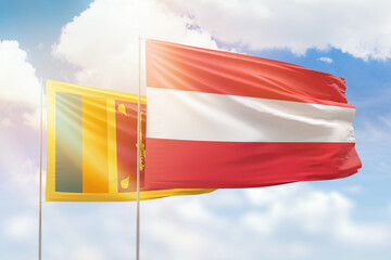 Sunny blue sky and flags of austria and sri lanka