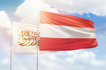 Sunny blue sky and flags of austria and afghanistan