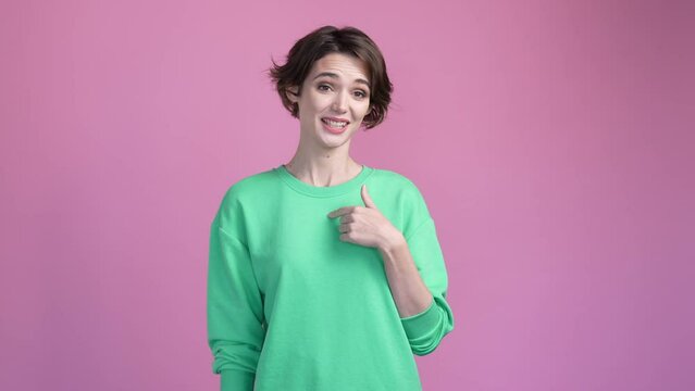 Lady winner point herself make thumb up sign isolated pastel color background