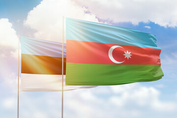 Sunny blue sky and flags of azerbaijan and estonia