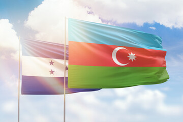 Sunny blue sky and flags of azerbaijan and honduras