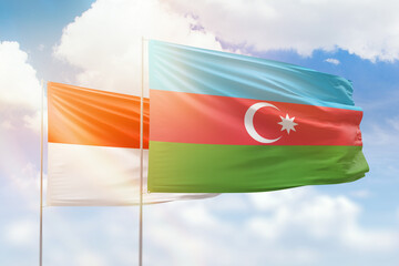 Sunny blue sky and flags of azerbaijan and indonesia