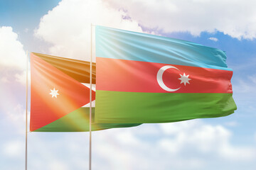 Sunny blue sky and flags of azerbaijan and jordan