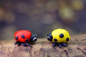 Figurines of two ladybugs made of plasticine close-up.