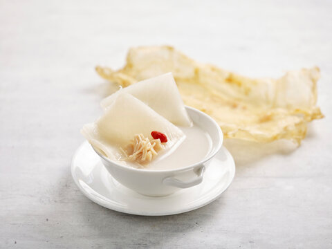 Shark Cartilage Soup With Fish Maw And Conpoy Served In A Bowl Isolated On Wooden Board Side View On Grey Background