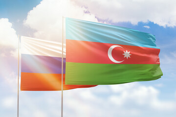 Sunny blue sky and flags of azerbaijan and russia