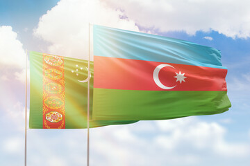 Sunny blue sky and flags of azerbaijan and turkmenistan
