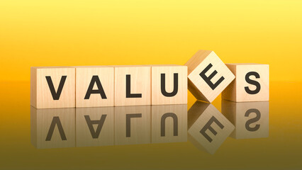 values word is made of wooden blocks lying on the yellow table, concept