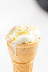 ice cream cone on white background and sugar particles on it