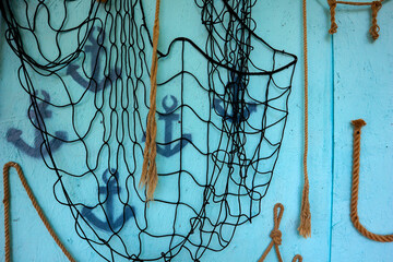 a wall with ropes in a nautical style.net, ropes, ropes, anchors. decorations