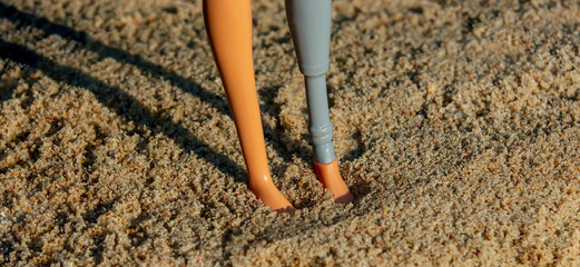 Doll foot stand on sand