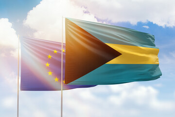 Sunny blue sky and flags of bahamas and european union