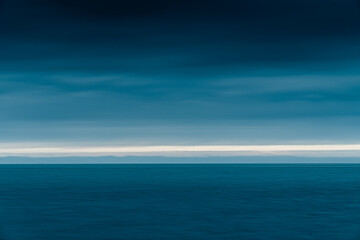 Fototapeta premium seascape abstract with panning motion combined with a long exposure. Image displays soft, pastel colors in a retro style.