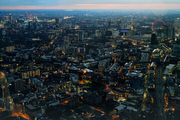 Aerial night view of west London, illuminated buildings glowing in dark