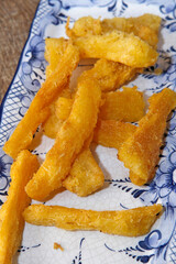 Fried manioc in white and blue porcelain dish