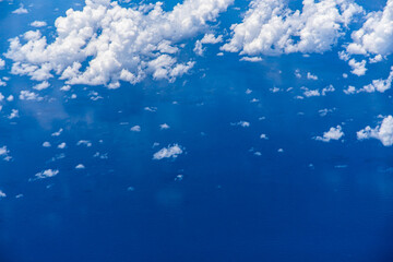Aerial view of blue ocean with clouds and reflection © DogmaDS