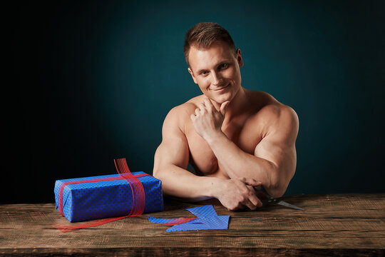 sports man gives a gift on a dark background - Powered by Adobe