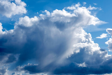 Cumulus and wispy clouds together before a rain storm