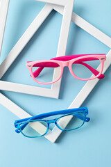 Child eyeglasses over pastel  background. Optical store, glasses selection for kids, eye test,...
