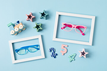 Child eyeglasses over pastel  background. Optical store, glasses selection for kids, eye test,...