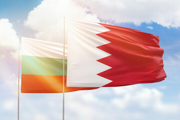Sunny blue sky and flags of bahrain and bulgaria