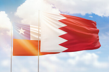Fototapeta na wymiar Sunny blue sky and flags of bahrain and chile