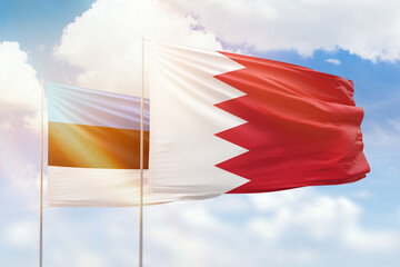 Sunny blue sky and flags of bahrain and estonia