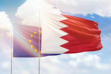 Sunny blue sky and flags of bahrain and european union