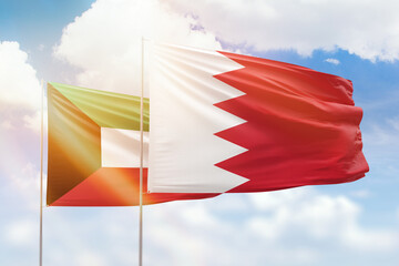 Sunny blue sky and flags of bahrain and kuwait