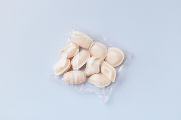 Flat lay top view of traditional portuguese egg yolk sweets Ovos Moles de Aveiro on blue background. Confectionery shop